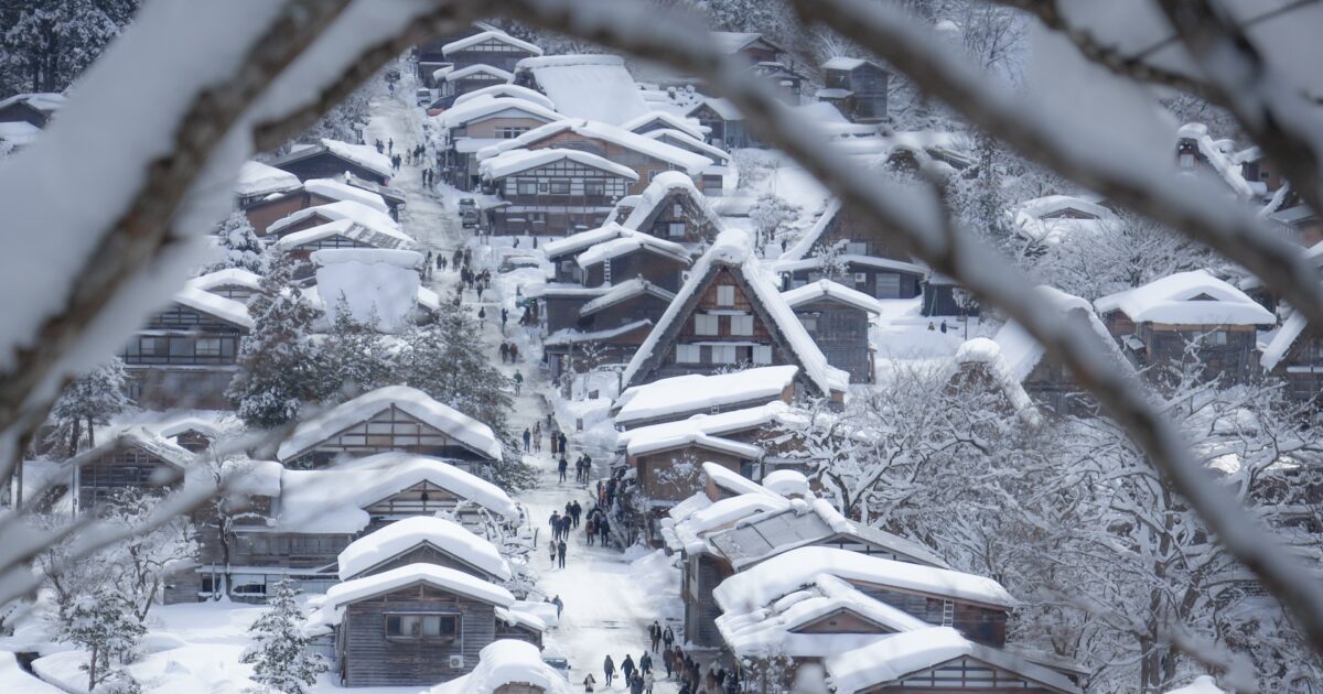 雪に包まれた白川郷の街並みと観光客